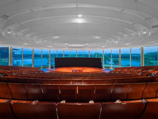 Interior of the VISTEC Auditorium (K Building) showing tiered seating and lake-view windows