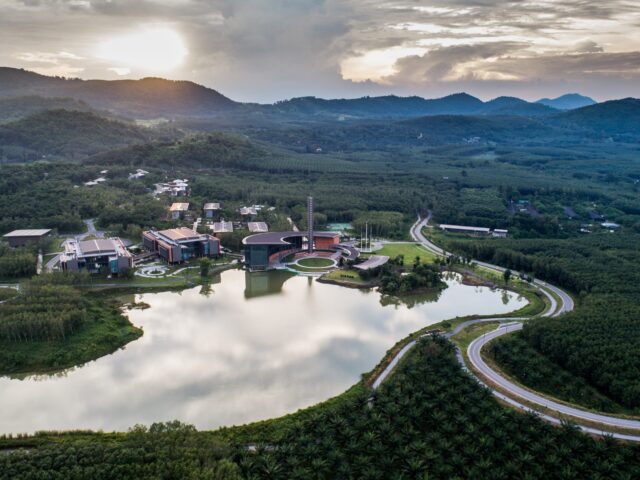 Aerial view of the full VISTEC campus and lake at sunset with the Wangchan Valley hills beyond