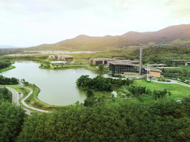 Aerial view of VISTEC campus lake and buildings against the Wangchan Valley hills